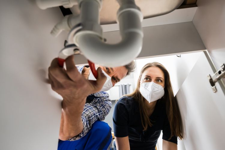 A blocked sink drain being repaired