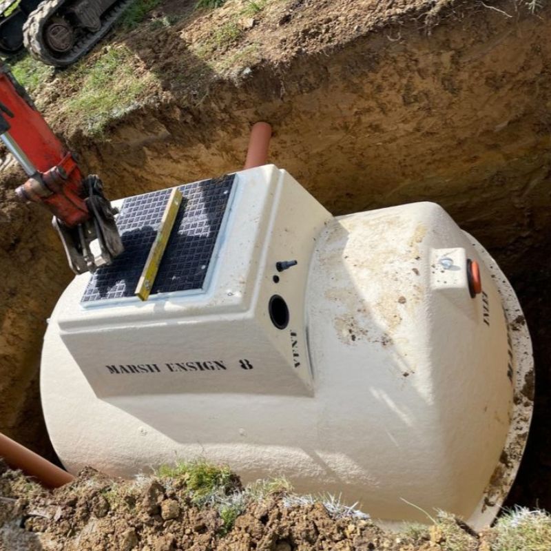 Lowering septic tank into the pit