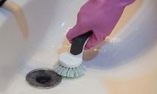 Person cleaning a home sink