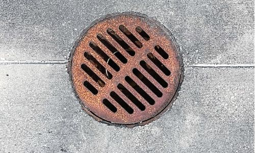 an outside drain placed on concrete floor