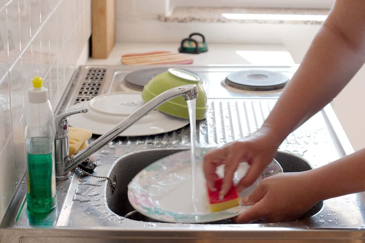 Washing dishes in the kitchen sink