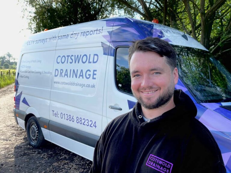 Stuart standing in front of a Cotswold Drainage van